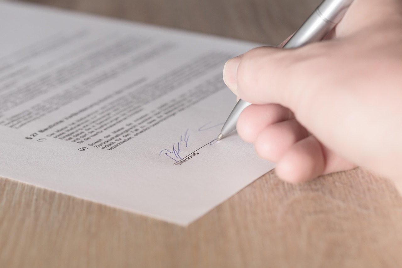 Editorial photo for What to Do If a Verbal Settlement Falls Apart Before Payment Arrives, showing business contracts, invoices, and settlement paperwork.
