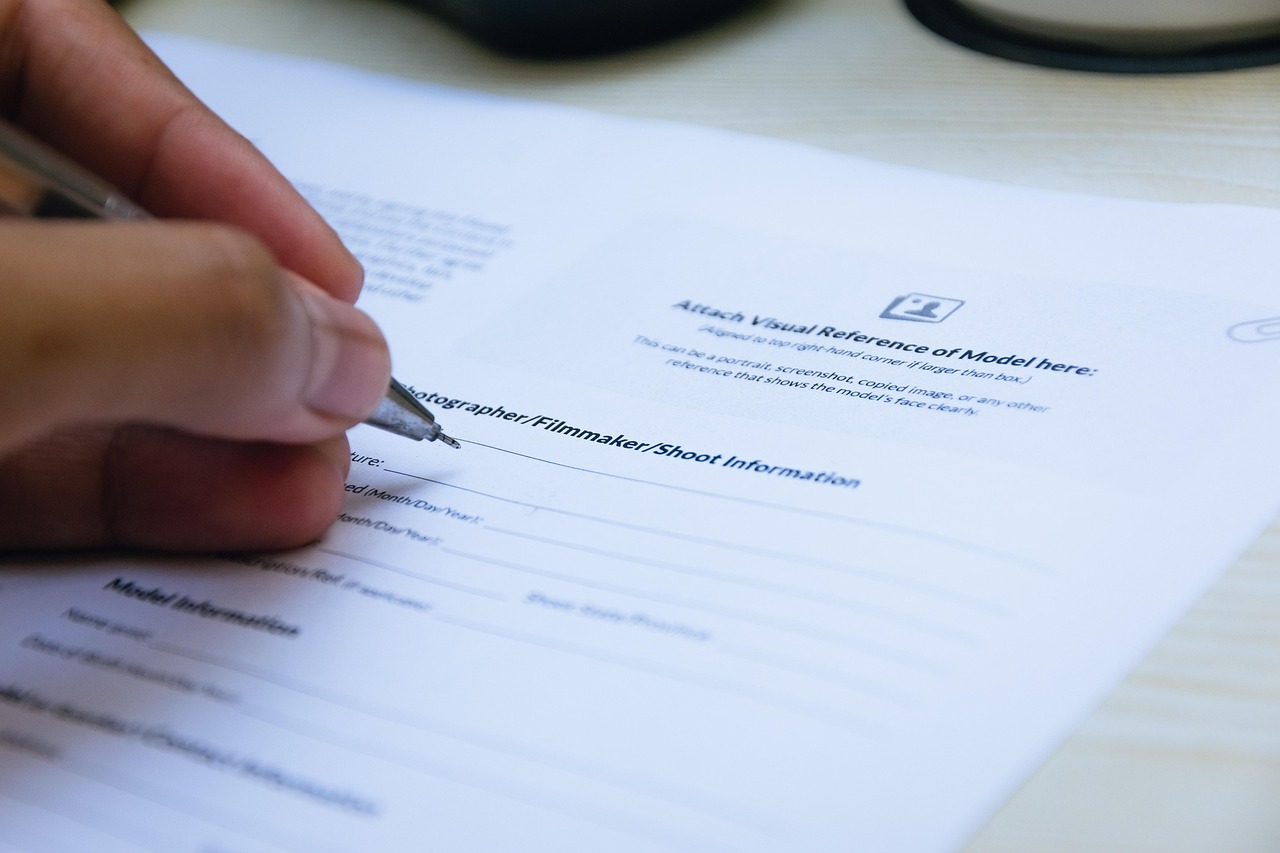Editorial photo for What Can I Sue My Employer for, showing employment records and workplace documents.