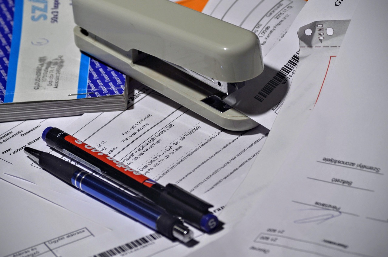 Editorial photo for Can I Sue My Employer for Unfair Wages, showing employment records and workplace documents.