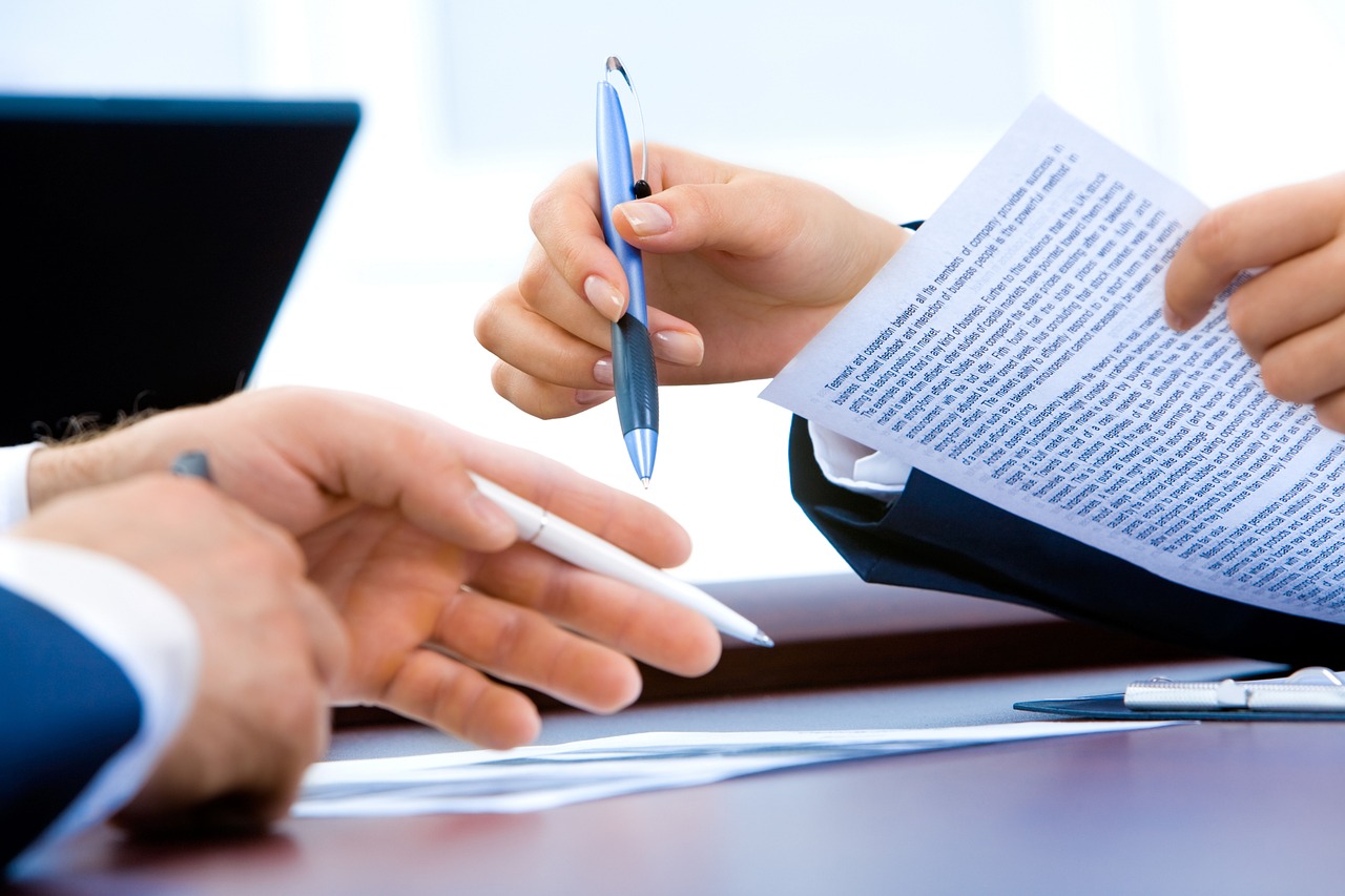 Editorial photo for Can I Sue My Employer for Breach of Contract, showing employment records and workplace documents.