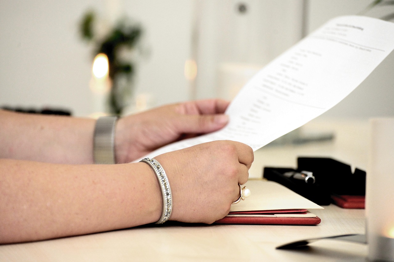 Editorial photo for Discrimination In Freelance Contracts: Seeking Redress For Biased Hiring Practices, showing business contracts, invoices, and settlement paperwork.