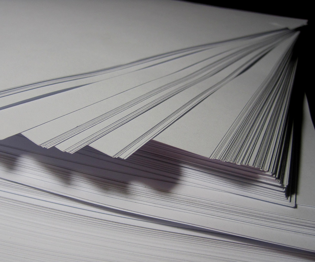 Editorial photo for Can I Sue My Employer for Hostile Work Environment, showing employment records and workplace documents.